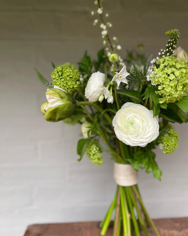 A BRIDE'S WHITE & GREEN BLOOMS